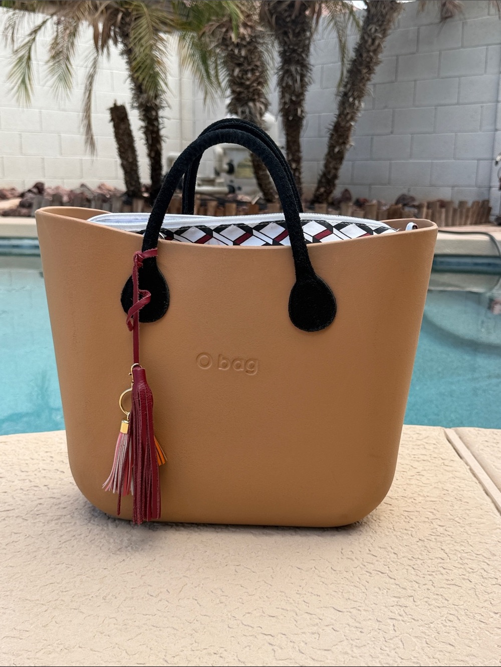 O bag Tan Tote with Black Handles and Red Tassel Accent